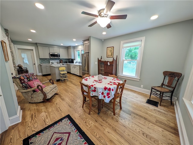 dining room featuring ceiling fan and light hardwood / wood-style flooring