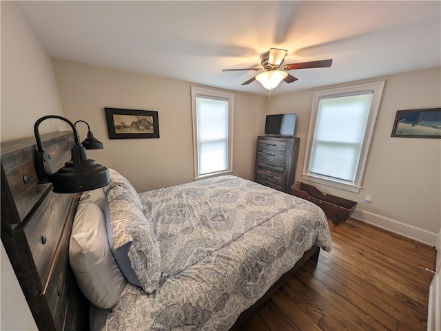 bedroom with dark wood-type flooring and ceiling fan