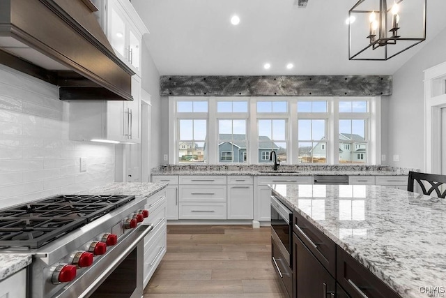 1015 Cold Springs Rd, Salina, NY 13088 - kitchen featuring white cabinetry, light wood-type flooring, stainless steel appliances, and pendant lighting