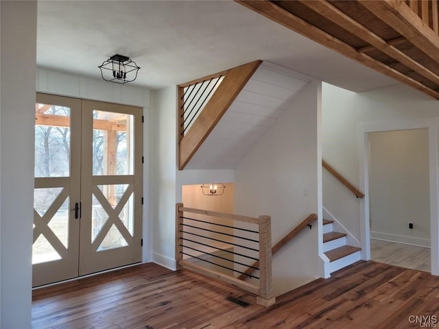 1015 Cold Springs Rd, Salina, NY 13088 - entryway with an inviting chandelier, french doors, and dark wood-type flooring