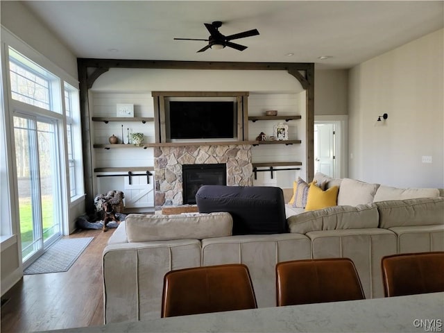 1015 Cold Springs Rd, Salina, NY 13088 - living room with ceiling fan, a fireplace, and hardwood / wood-style floors