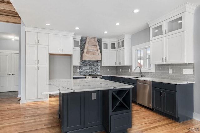 1015 Cold Springs Rd, Salina, NY 13088 - kitchen with a kitchen island, appliances with stainless steel finishes, light wood-type flooring, and white cabinets