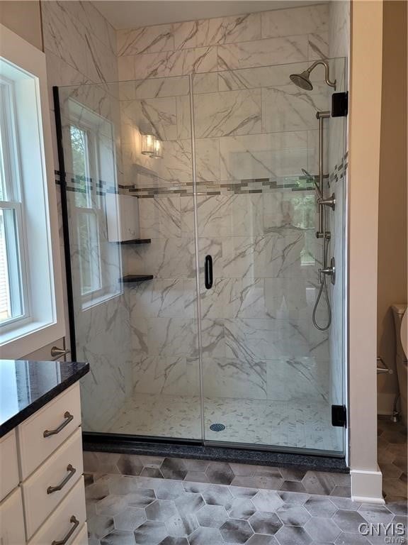 1015 Cold Springs Rd, Salina, NY 13088 - bathroom featuring vanity, walk in shower, and plenty of natural light