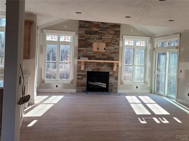 1015 Cold Springs Rd, Salina, NY 13088 - unfurnished living room featuring light hardwood / wood-style flooring, a fireplace, and plenty of natural light