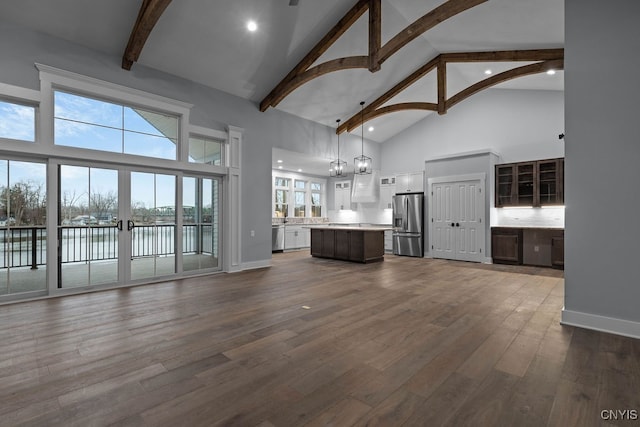 1015 Cold Springs Rd, Salina, NY 13088 - unfurnished living room featuring a water view, hardwood / wood-style flooring, high vaulted ceiling, and beamed ceiling