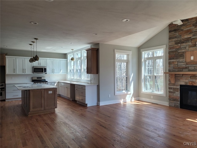 1015 Cold Springs Rd, Salina, NY 13088 - kitchen featuring dark hardwood / wood-style flooring, white cabinets, stainless steel appliances, and a kitchen island