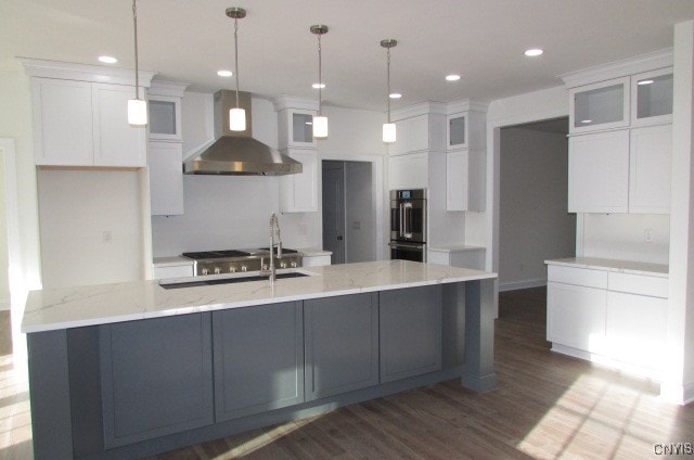 1015 Cold Springs Rd, Salina, NY 13088 - kitchen featuring hanging light fixtures, wall chimney exhaust hood, dark hardwood / wood-style floors, and white cabinets