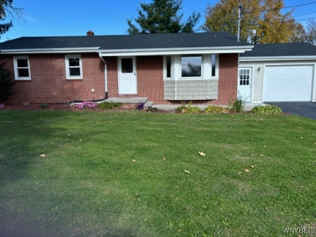 single story home featuring a front lawn and a garage