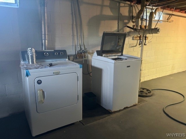 clothes washing area with washing machine and dryer