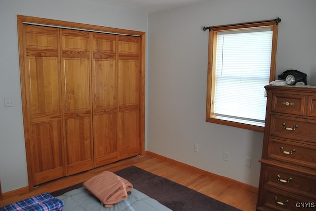 bedroom with a closet and light wood-type flooring