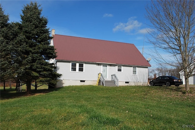 rear view of property with a yard