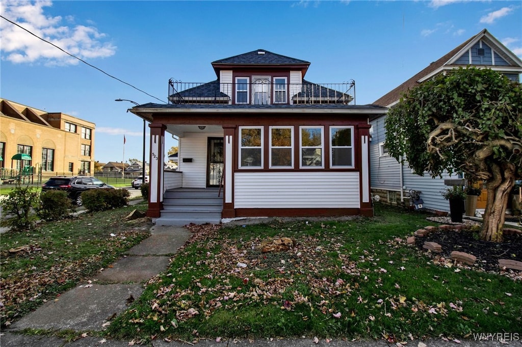 view of front of house featuring a balcony