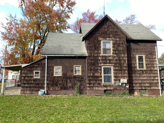 rear view of property with a lawn