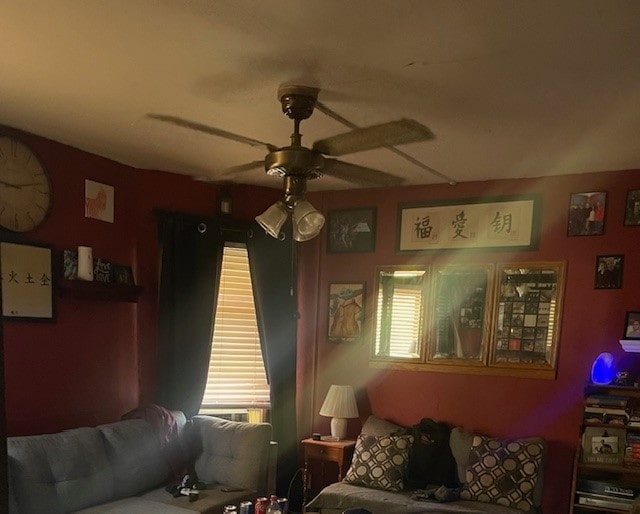 living room featuring ceiling fan and a wealth of natural light