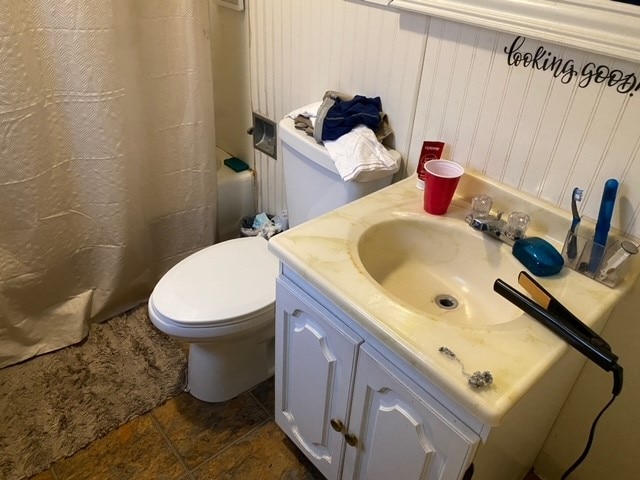 bathroom featuring vanity, toilet, tile patterned floors, and a shower with shower curtain