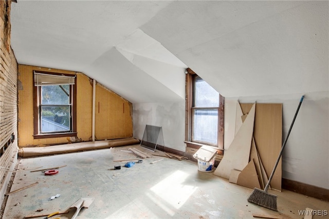 additional living space featuring lofted ceiling