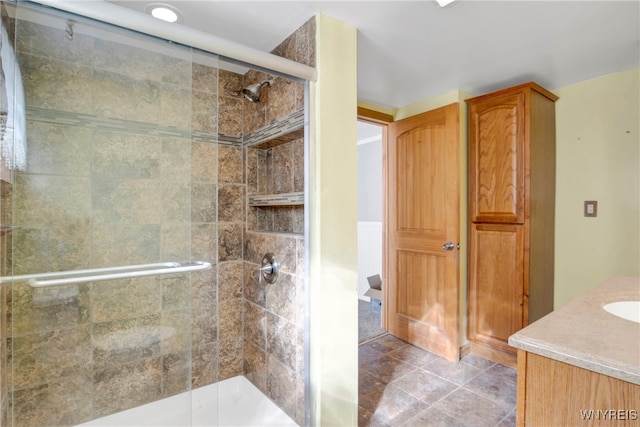 bathroom featuring vanity, tile patterned flooring, and an enclosed shower