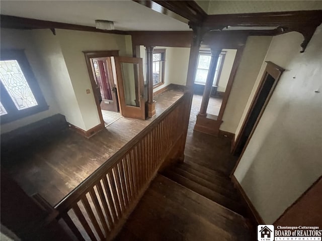 staircase featuring hardwood / wood-style flooring and decorative columns