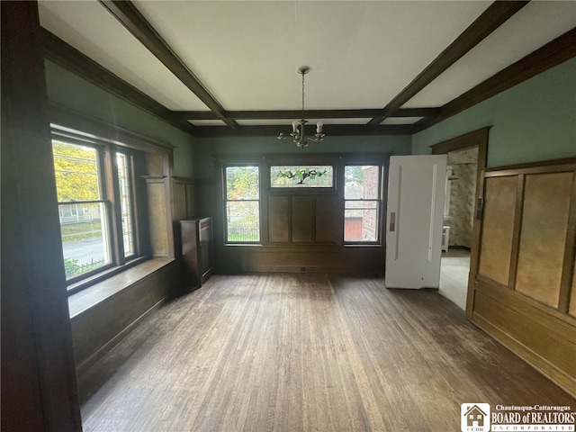 interior space with beam ceiling, coffered ceiling, wood-type flooring, and a chandelier