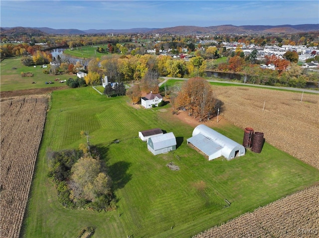 drone / aerial view with a water and mountain view and a rural view