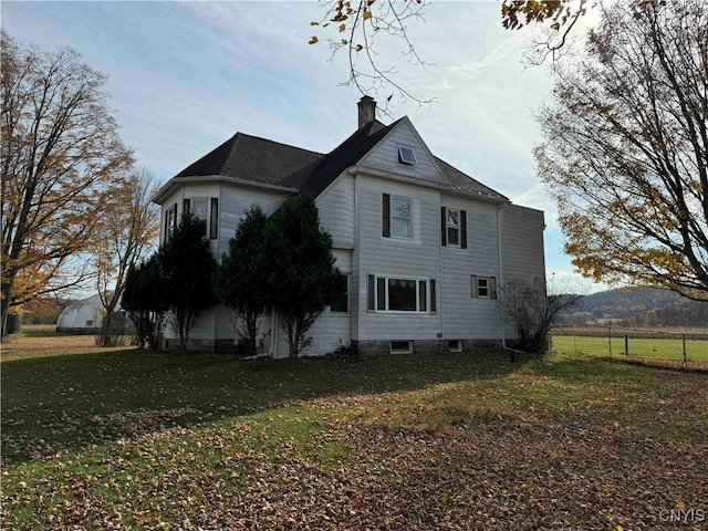 view of property exterior with a mountain view and a yard