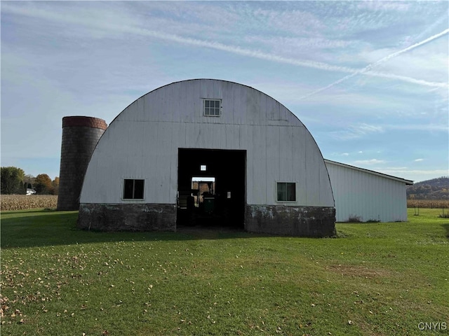 view of outdoor structure featuring a lawn