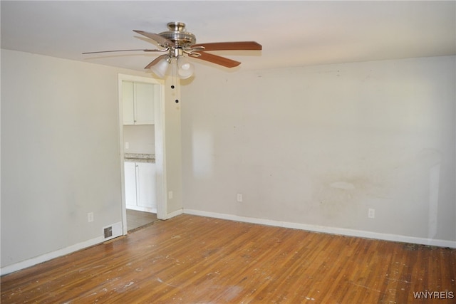 empty room featuring hardwood / wood-style floors and ceiling fan