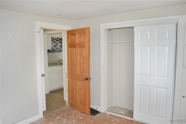 unfurnished bedroom with a closet and sink