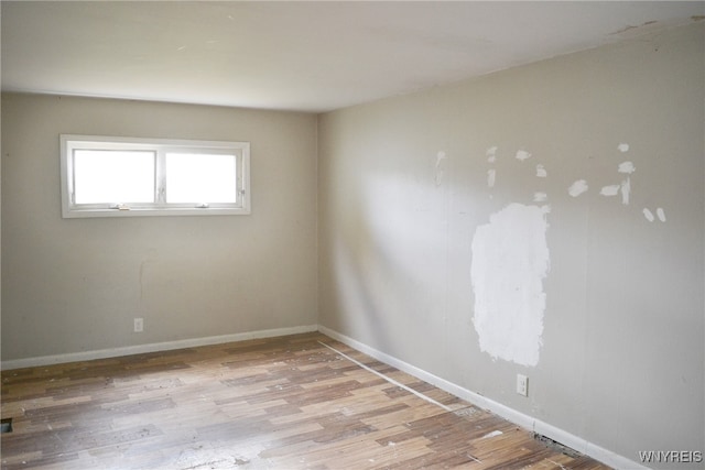 unfurnished room featuring light hardwood / wood-style flooring