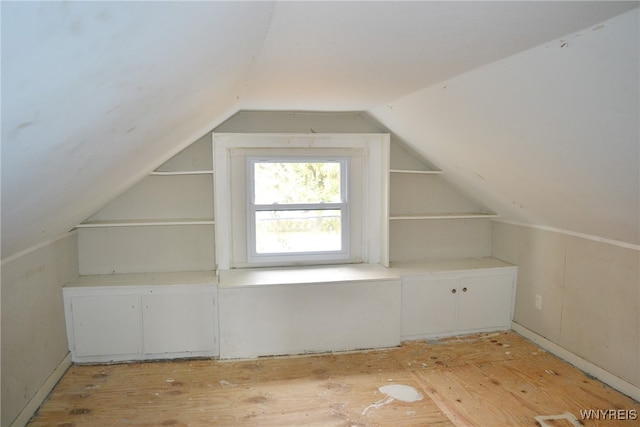 bonus room featuring light hardwood / wood-style flooring and vaulted ceiling