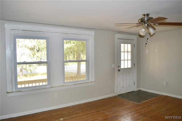 interior space with dark wood-type flooring, ceiling fan, and a wealth of natural light