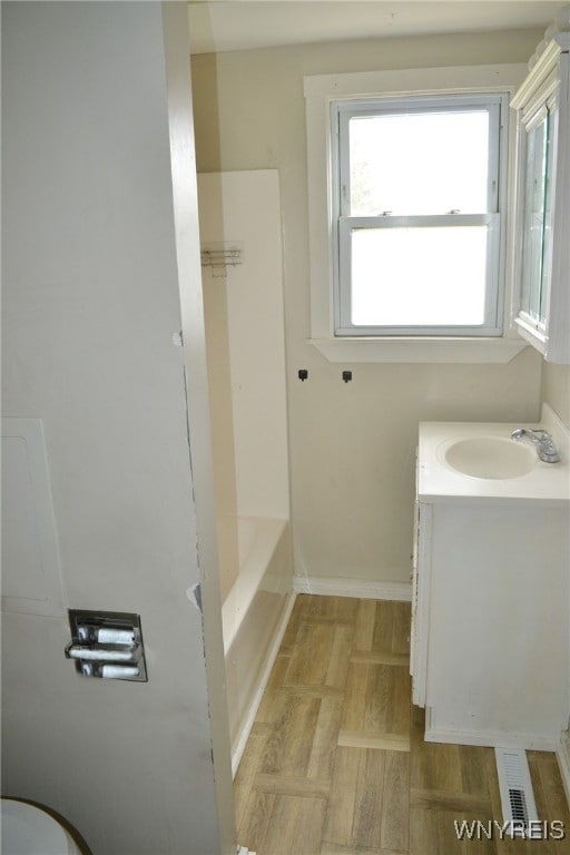 full bathroom featuring vanity, hardwood / wood-style flooring, toilet, and separate shower and tub