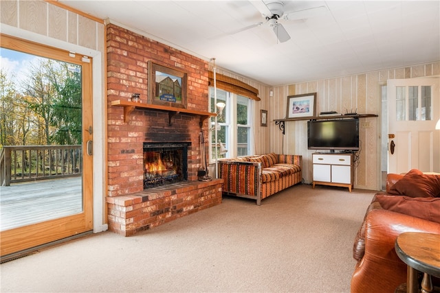 living room with ceiling fan, carpet floors, and a fireplace
