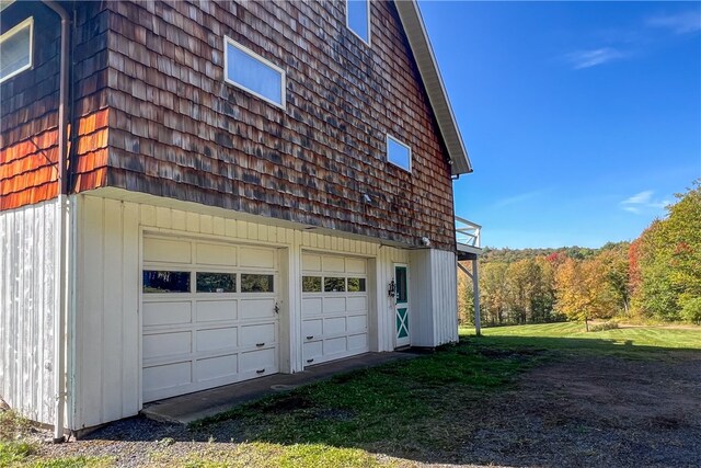 view of property exterior with a yard and a garage