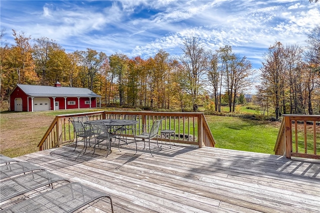 wooden deck with a garage and a lawn