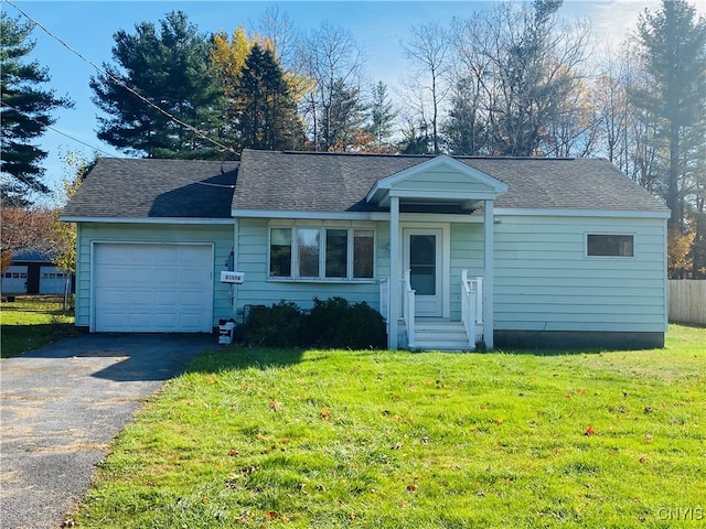 ranch-style home with a garage and a front lawn