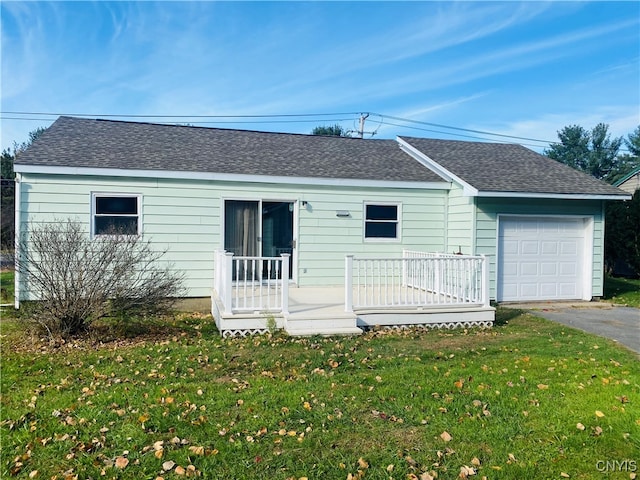 single story home featuring a garage and a front lawn