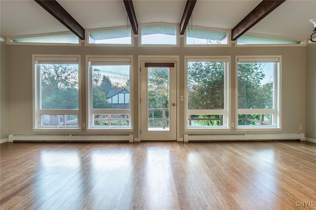 unfurnished sunroom with vaulted ceiling with beams, a baseboard radiator, and plenty of natural light