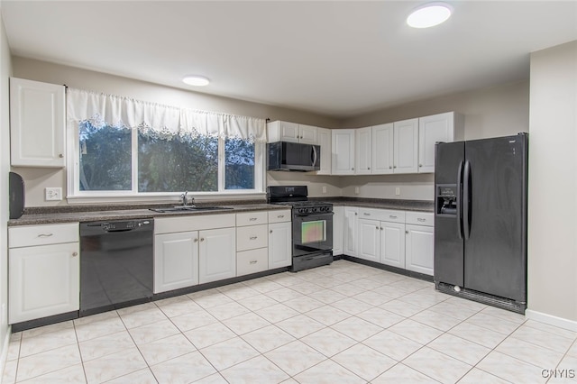 kitchen with sink, black appliances, and white cabinets