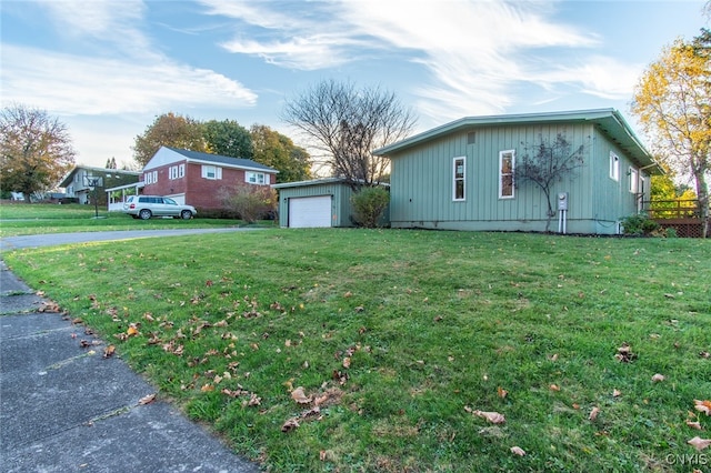 view of home's exterior featuring an outdoor structure, a garage, and a lawn