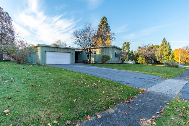 single story home featuring a front lawn and a garage