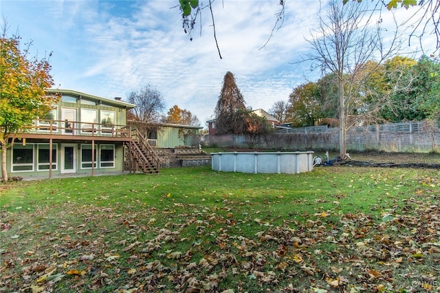 view of yard with a pool side deck