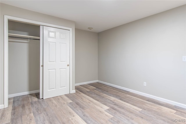 unfurnished bedroom featuring a closet and light hardwood / wood-style flooring