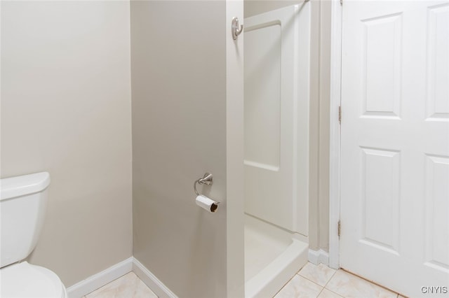 bathroom with tile patterned floors, a shower, and toilet