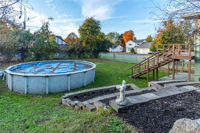 view of pool with a yard