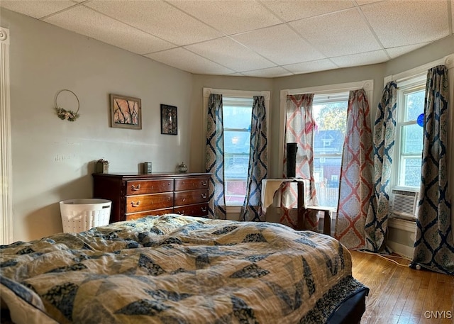 bedroom with hardwood / wood-style flooring and a drop ceiling