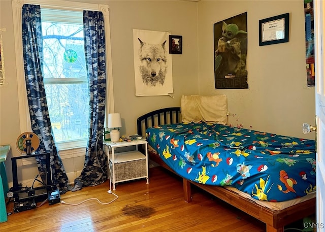 bedroom with hardwood / wood-style flooring