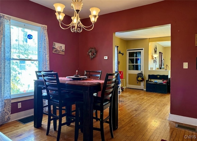 dining area featuring a notable chandelier and hardwood / wood-style flooring