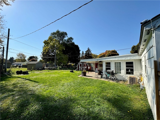 view of yard featuring a patio area and central AC unit