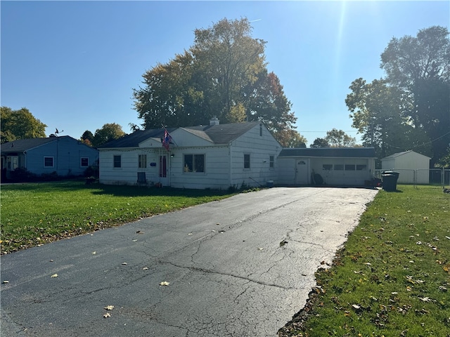 ranch-style house with a front yard and a garage